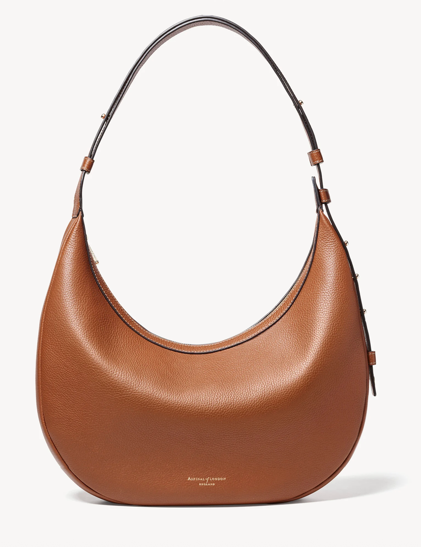 A brown pebbled leather hobo shoulder bag with a single shoulder strap and small gold brand lettering on the front, shown against a plain white background.