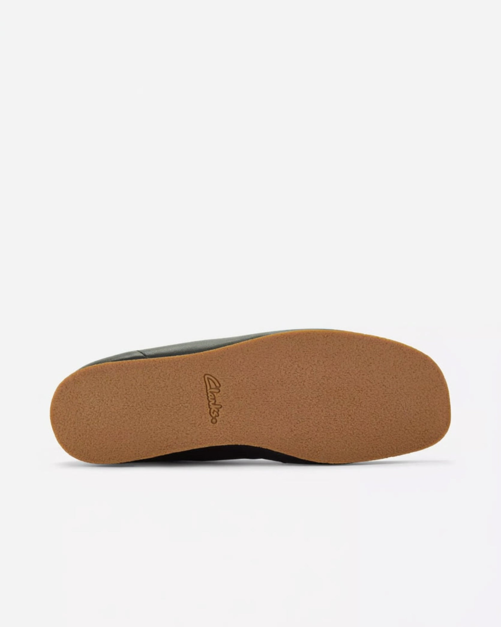 The outsole of a Clarks shoe, showing a textured tan rubber bottom with the Clarks logo embossed in the center, photographed against a clean white background.