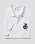 A folded white polo shirt with a collar and three-button placket, featuring a colorful embroidered school crest on the left chest. The neck label reads 'ANNEA FRIEWEIT'.