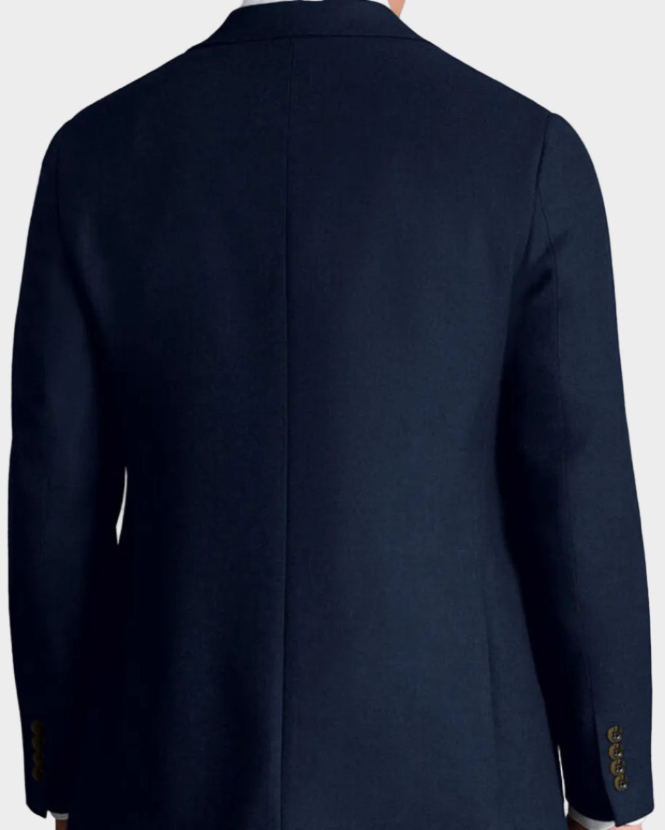 Man wearing a navy blazer on a beige background