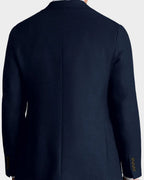 Man wearing a navy blazer on a beige background