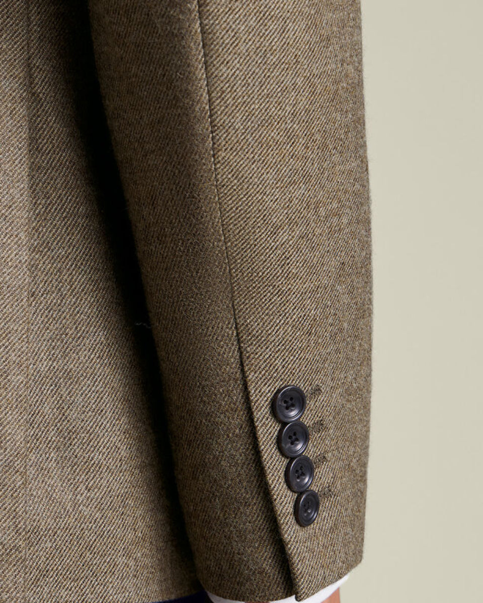 Brown textured blazer with three buttons on a neutral background