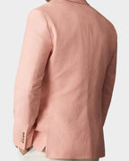 Man wearing a pink blazer against a beige background