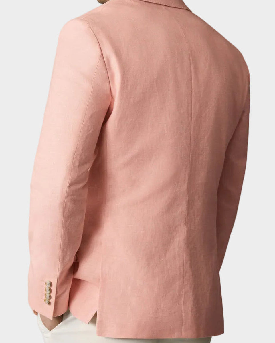 Man wearing a pink blazer against a beige background