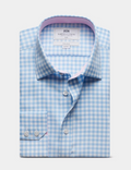 A folded light blue and white gingham dress shirt by Harris & Curtis, featuring a light pink inner collar lining and white buttons, set against a light gray background.