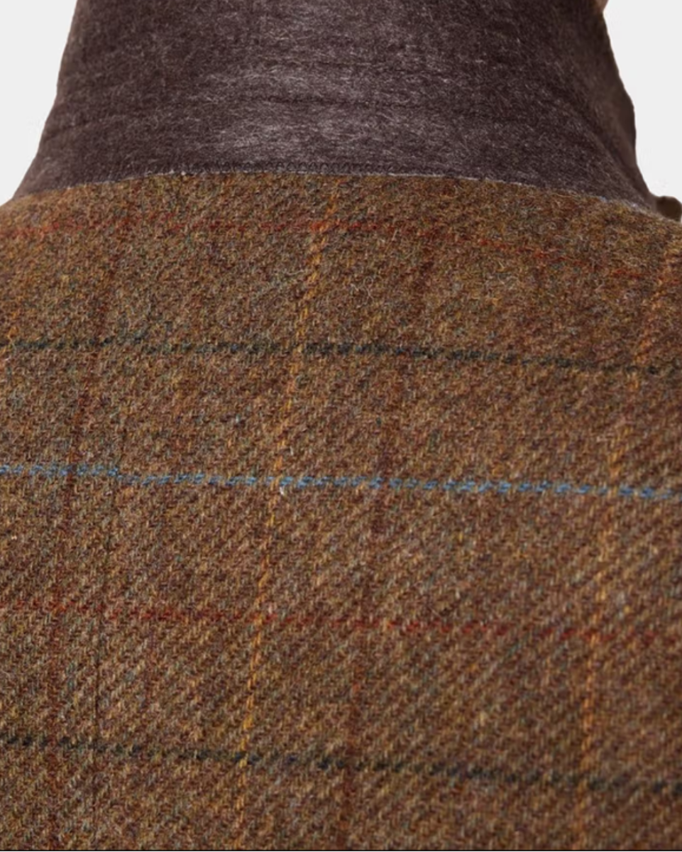 Close-up of a brown and beige plaid tweed jacket with a dark brown corduroy-like collar, showing the fabric texture and weave.