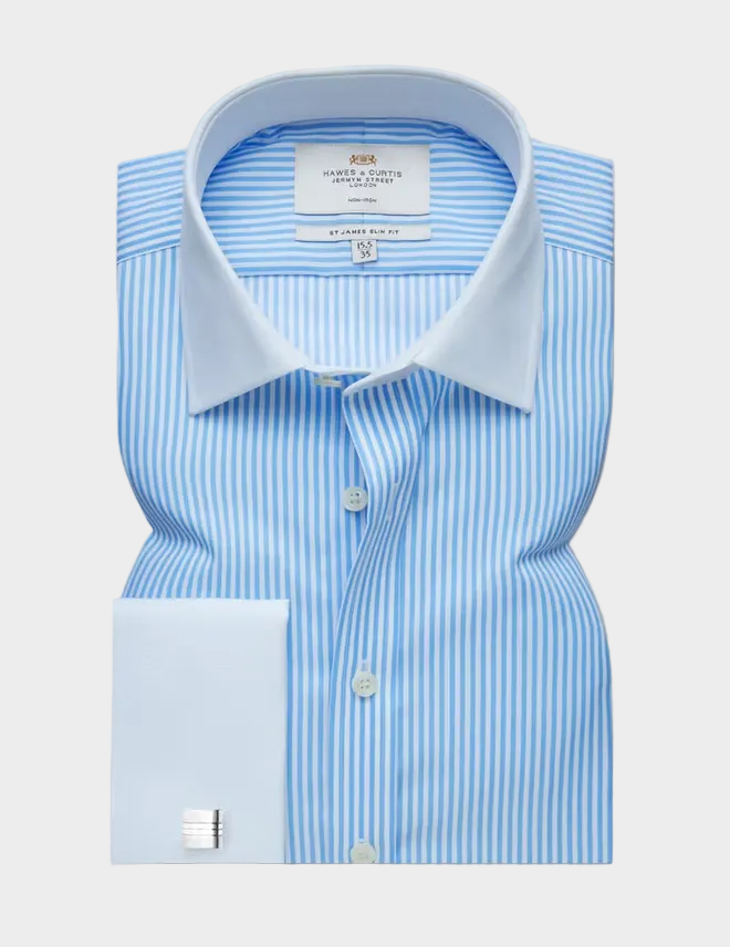 A light blue and white vertically striped dress shirt with a solid light blue collar and a matching light blue cuff, displayed flat against a solid taupe background.