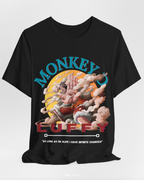 A black short-sleeve graphic t-shirt featuring a colorful print of Monkey Luffy from One Piece. The graphic includes the words 'MONKEY LUFFY' in stylized blue and red lettering, with Monkey Luffy depicted in the center against a yellow sun and clouds.