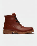 A single brown leather lace-up ankle boot shown in profile against a light gray background. The boot features dark brown laces, metal eyelets, a stitched leather upper, and a brown rubber sole.
