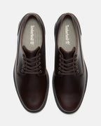 A pair of Timberland dark brown leather lace-up boots shown from a top-down view on a light gray background.