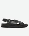 Black sandal with a buckle on a light gray background