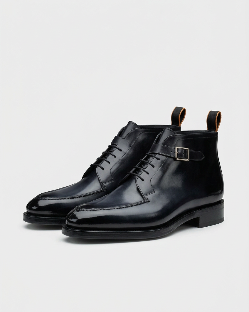 Black buckle-boot pair swapped onto the grey background at the same ground level