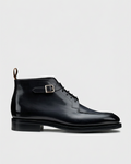 Black lace-up buckle boot swap preserving the grey background and ground level