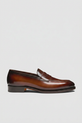 Brown loafer swap preserving the boot image’s background and ground level
