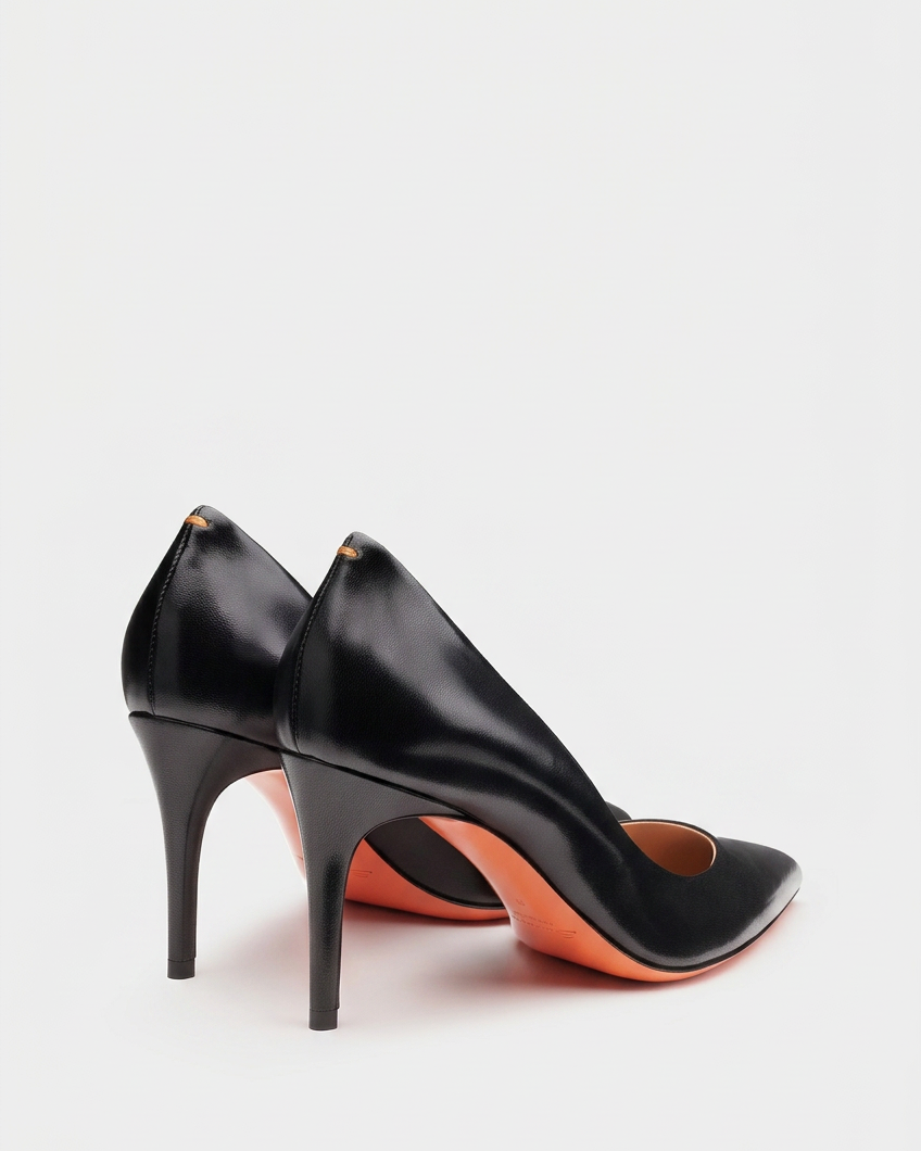 Plain black pump pair swapped onto the existing pale background at the same low baseline