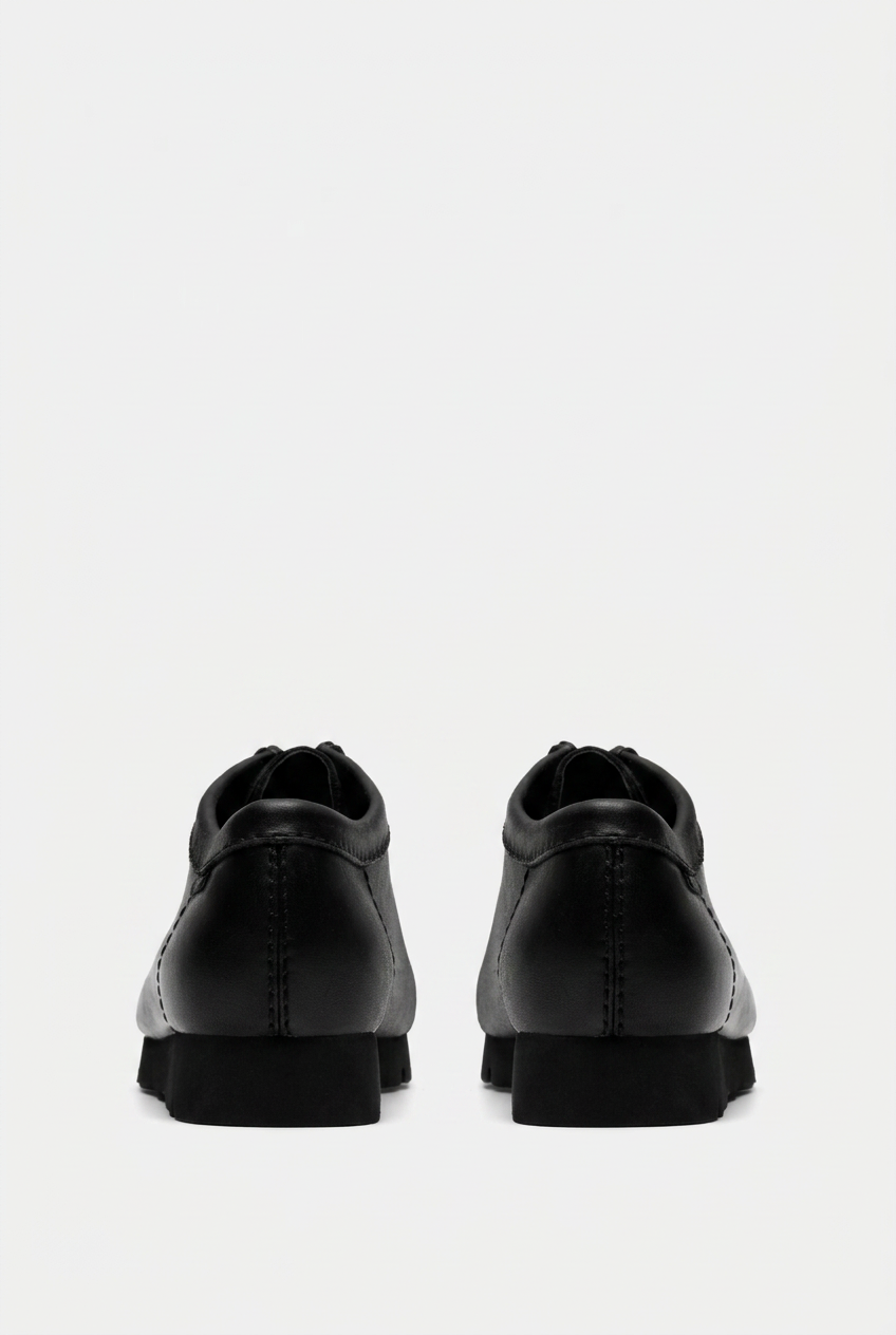 Wallabee rear view on the grey background, aligned to the trainer’s baseline